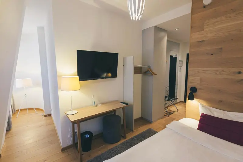 Une chambre lumineuse avec un bureau et un lit.
