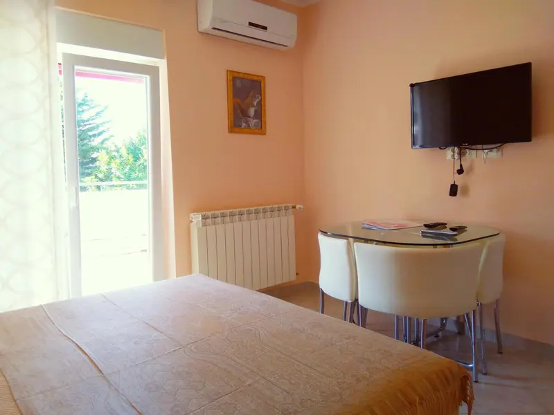 Une chambre lumineuse avec un lit et une petite table.