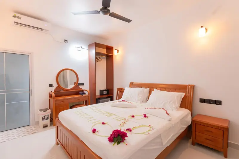 Une chambre lumineuse avec un lit décoré de fleurs.