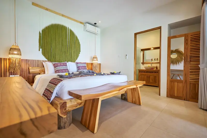 Une chambre lumineuse avec un grand lit et une décoration en bois.