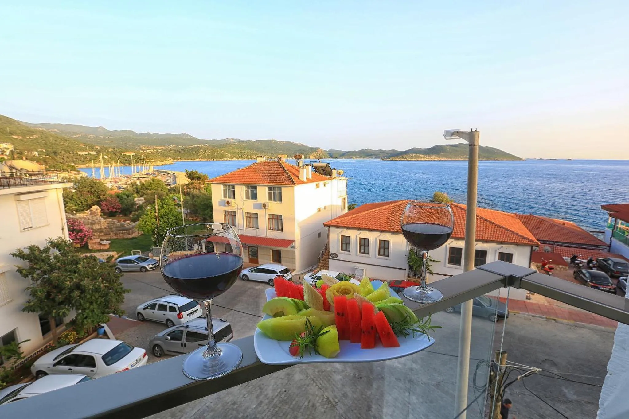 Une table de balcon offre une vue sur la mer et les bâtiments environnants.