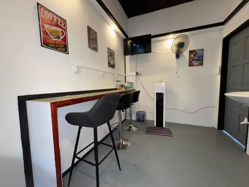 Un comptoir avec des tabourets hauts dans un espace intérieur lumineux.