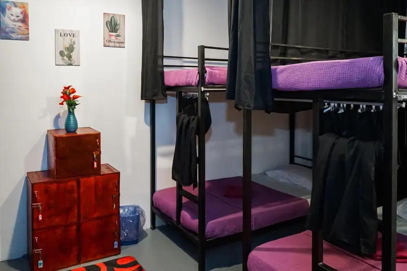 Une chambre avec des lits superposés et une commode rouge.