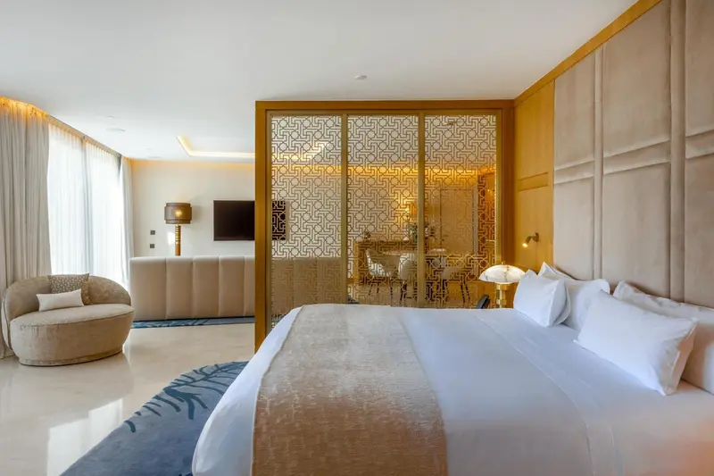 Une chambre spacieuse avec un grand lit et un coin salon.