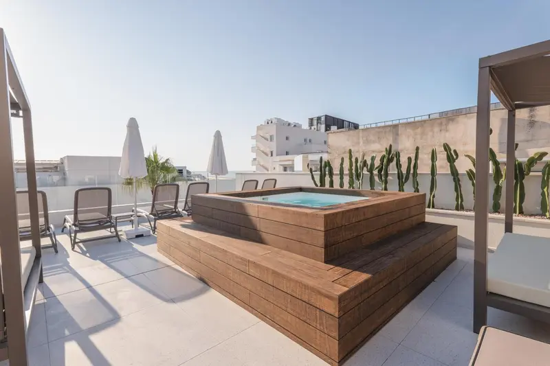 Terrasse avec jacuzzi et mobilier de détente.
