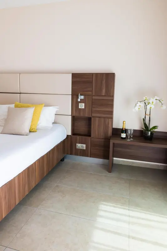 Une chambre lumineuse avec un grand lit et une décoration sobre.