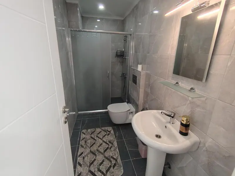 Une salle de bain moderne avec douche à l'italienne et vasque.