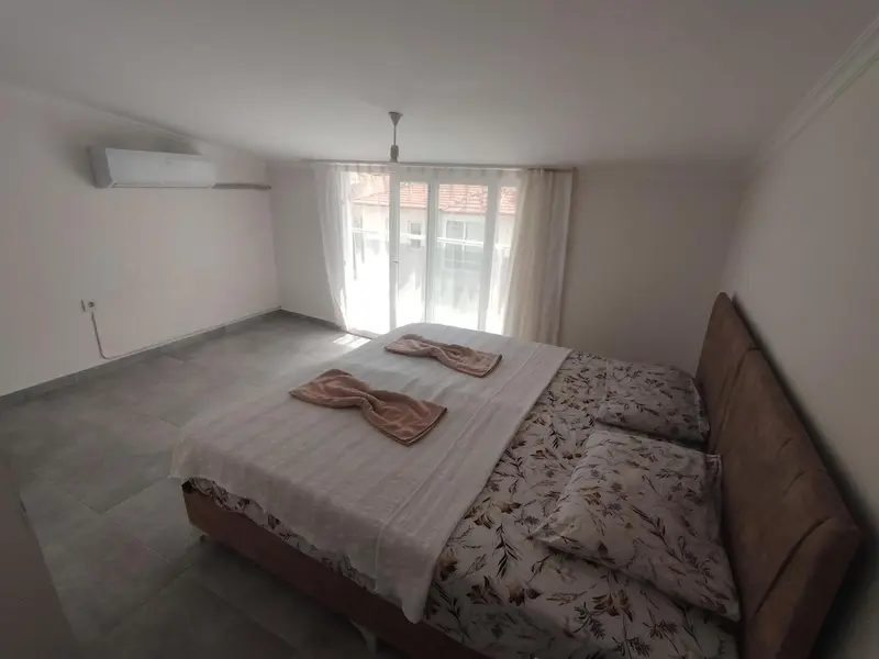 Une chambre lumineuse avec un grand lit et une fenêtre.