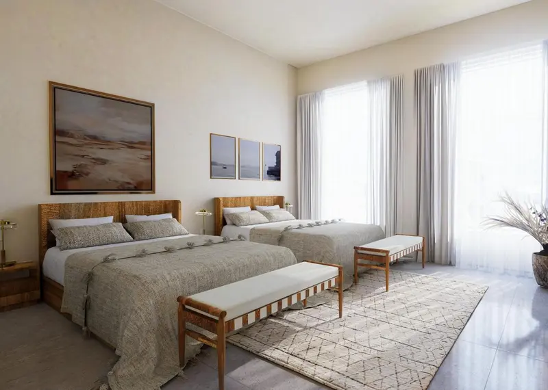 Deux lits simples dans une chambre lumineuse et décorée avec des œuvres d'art.