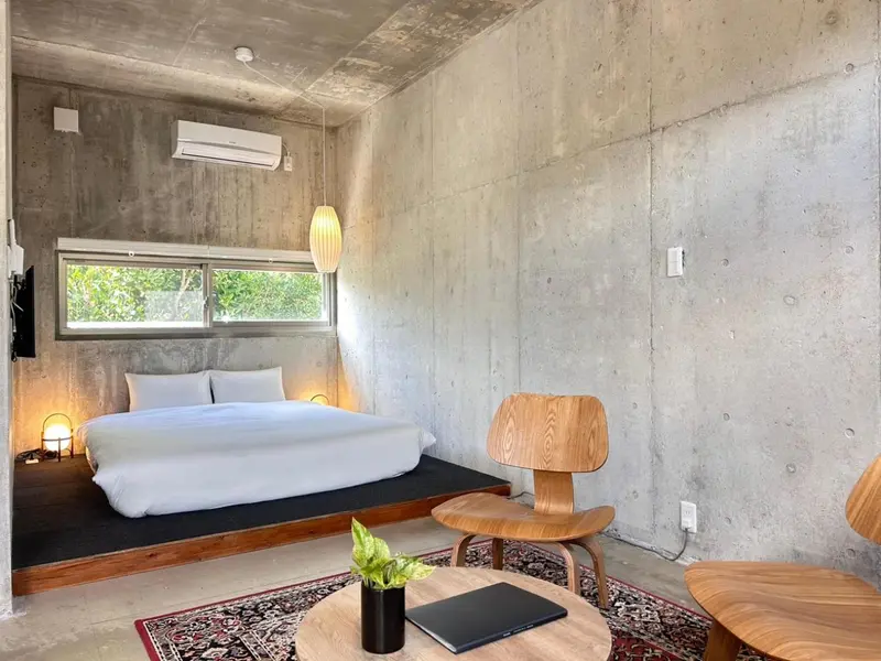 Une chambre minimaliste avec un grand lit et une décoration sobre.