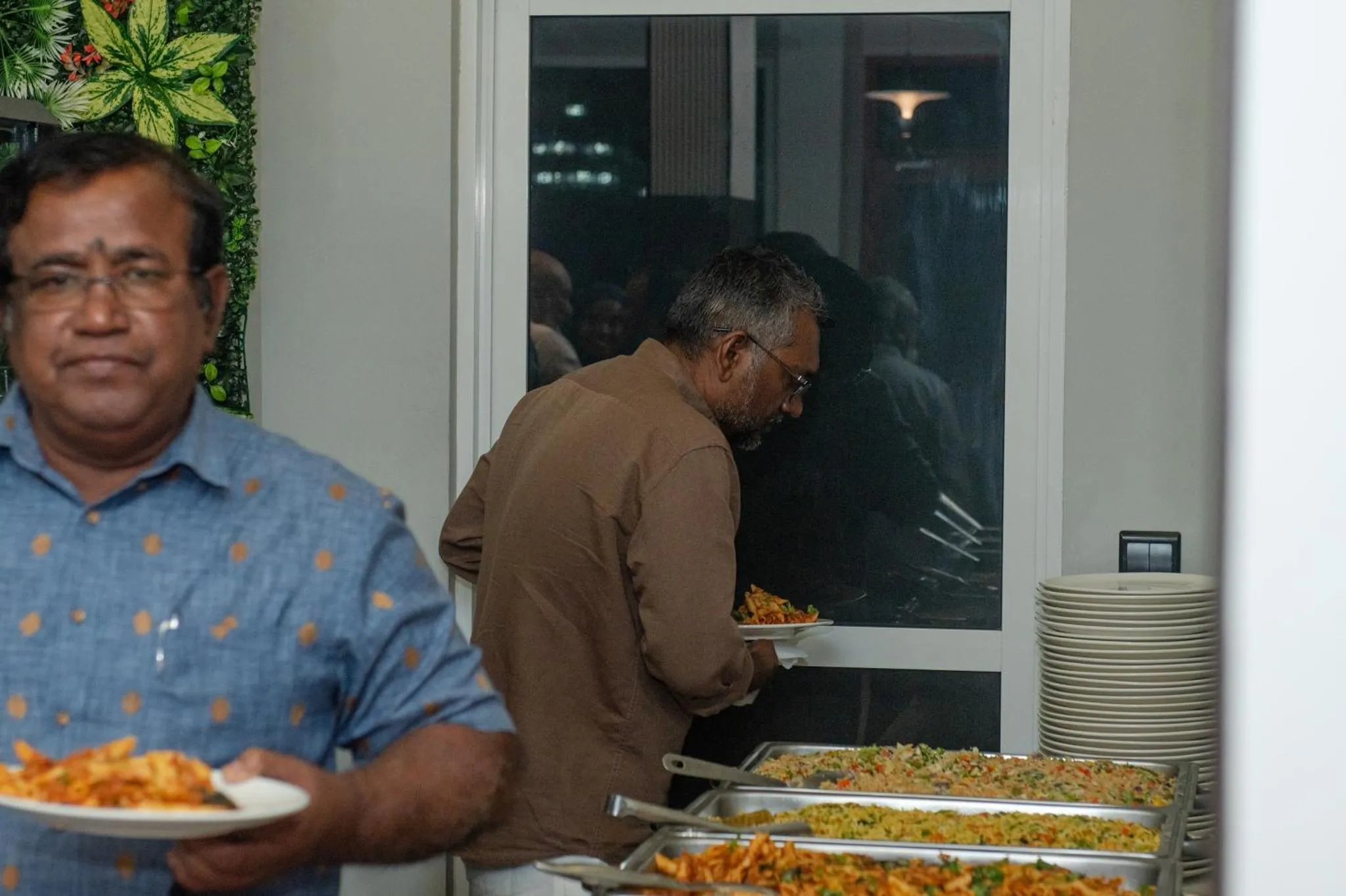 Des personnes se servent à un buffet de nourriture.
