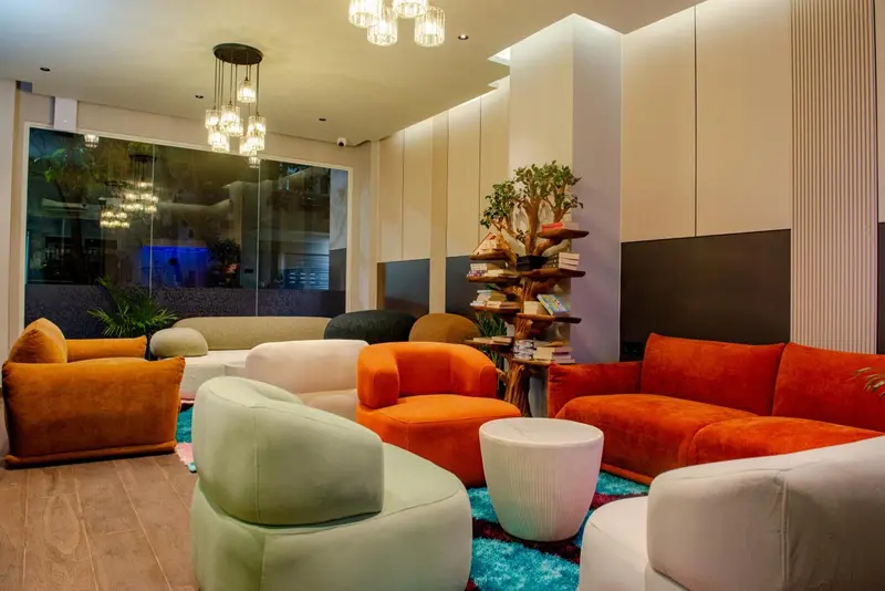 Un espace de détente intérieur avec des fauteuils colorés et une plante décorative.