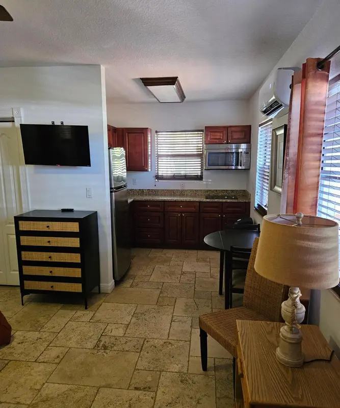 Une pièce lumineuse avec une kitchenette et une table à manger.
