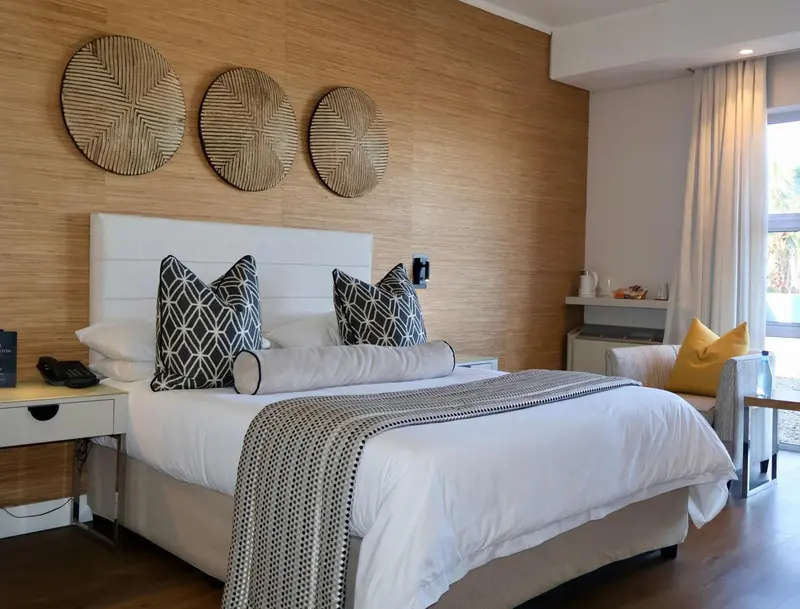 Une chambre lumineuse avec un grand lit et une décoration moderne.