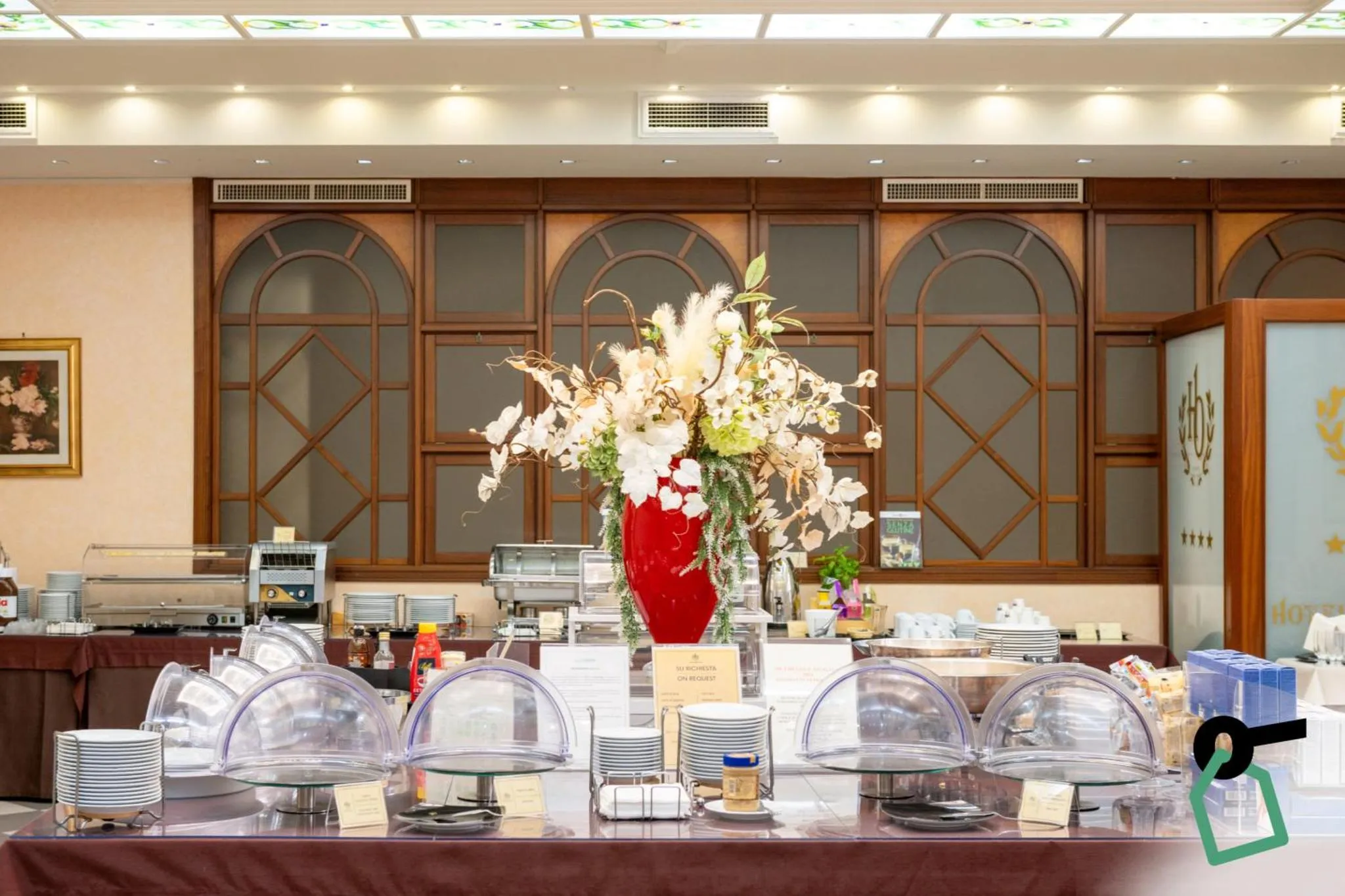 Un buffet de nourriture est présenté dans une salle lumineuse avec de grandes fenêtres.