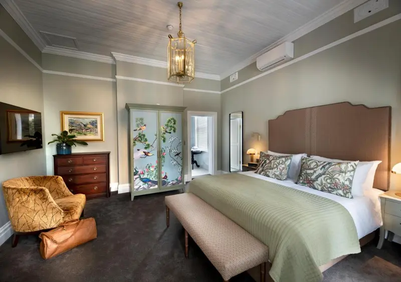 Une chambre lumineuse avec un grand lit et un mobilier en bois.