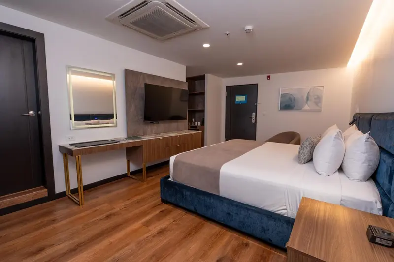 Une chambre moderne avec un grand lit et un espace bureau.