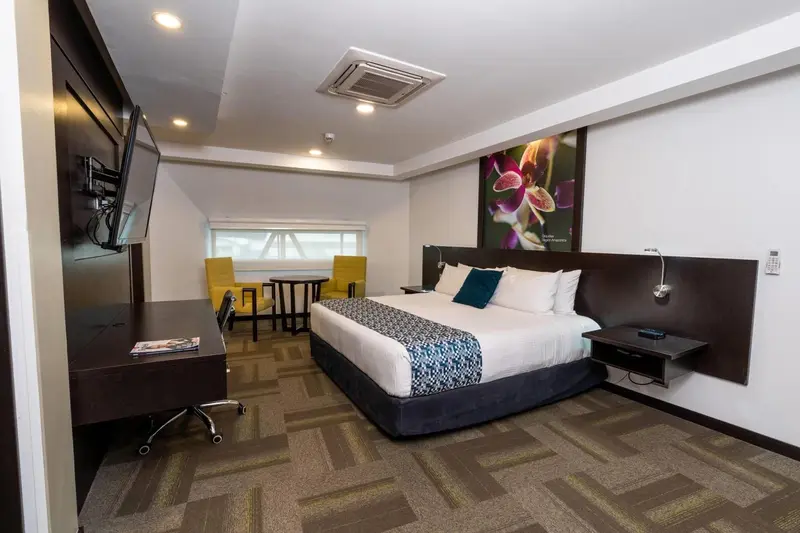 Une chambre d'hôtel moderne avec un grand lit et un espace détente.