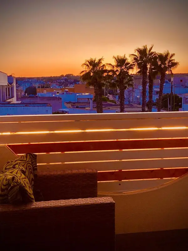 Terrasse avec mobilier d'extérieur au coucher du soleil.