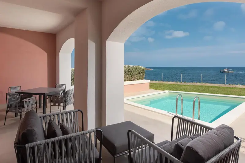Terrasse ombragée avec salon et petite piscine donnant sur la mer.