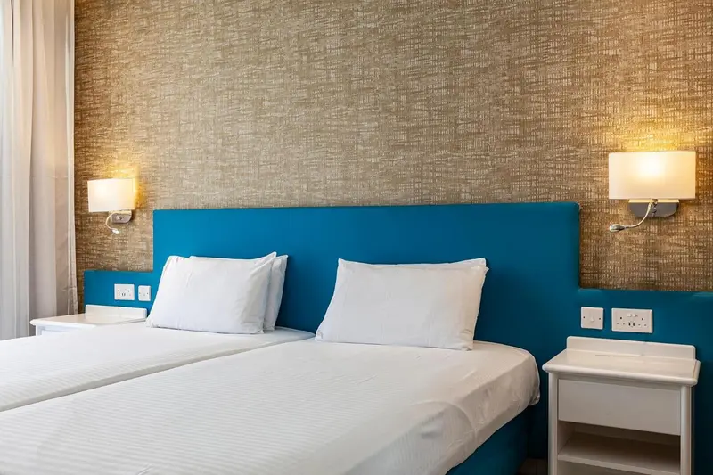 Un lit avec des oreillers blancs dans une chambre décorée.