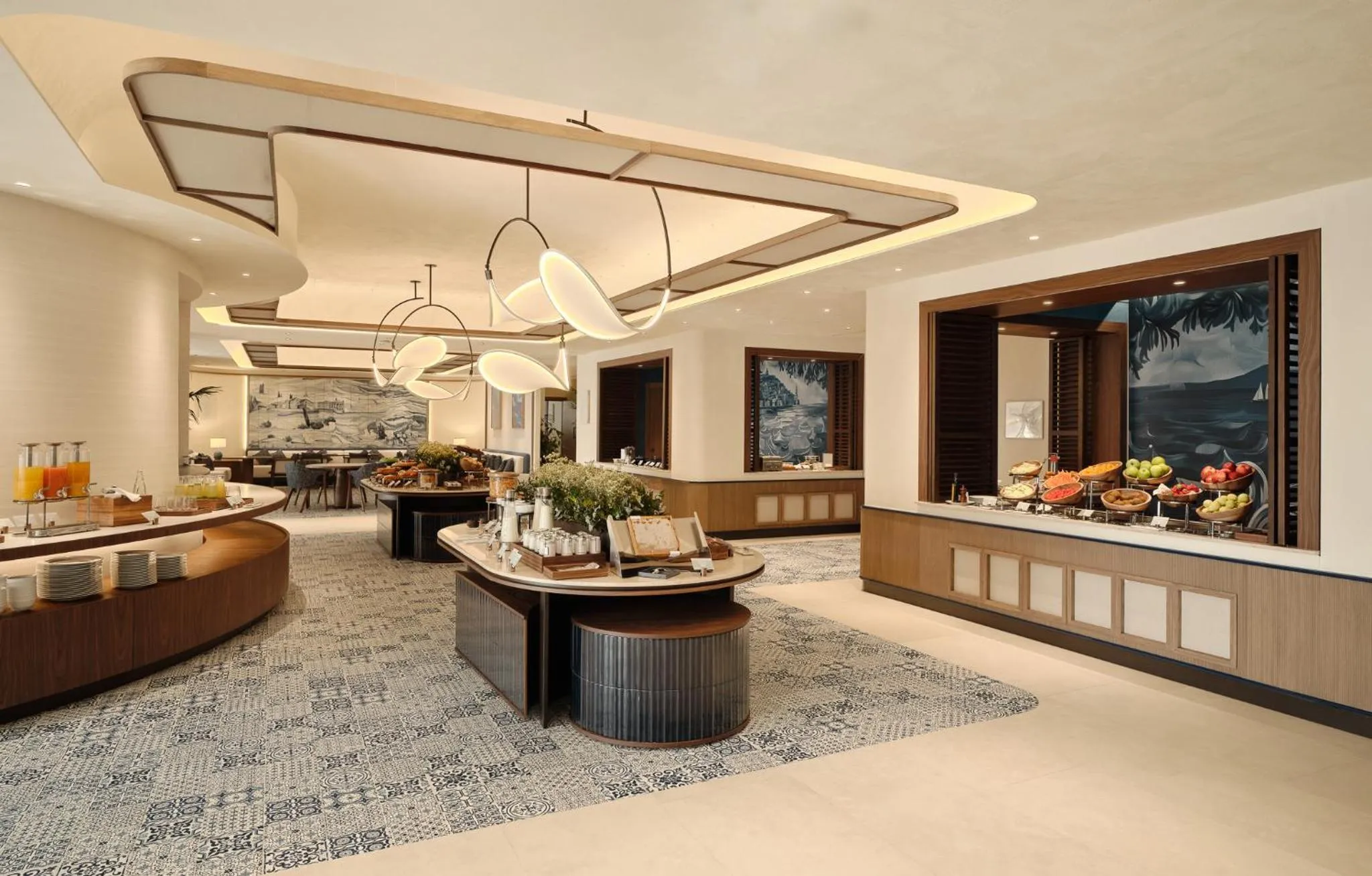 Une salle lumineuse présente un buffet garni de plats variés et de fruits frais.