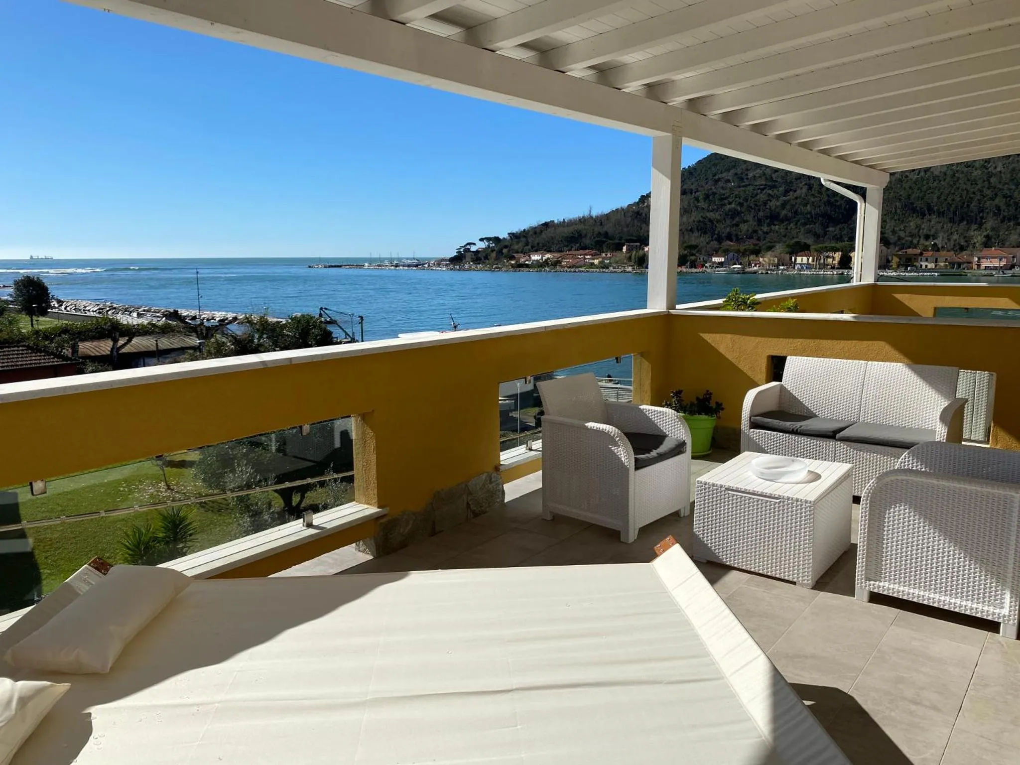 Terrasse aménagée avec mobilier d'extérieur donnant sur la mer.