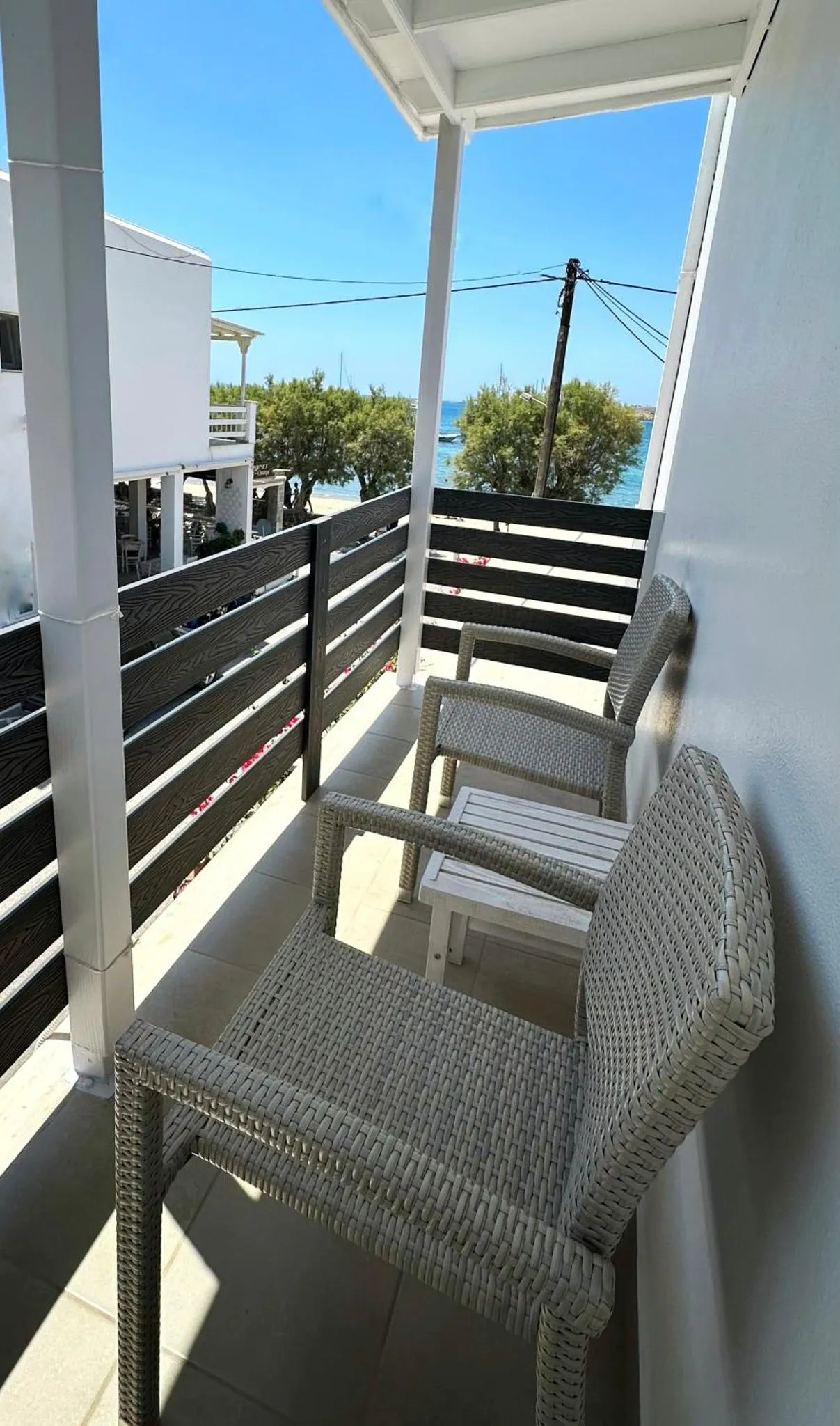 Terrasse avec mobilier d'extérieur et vue sur la mer.