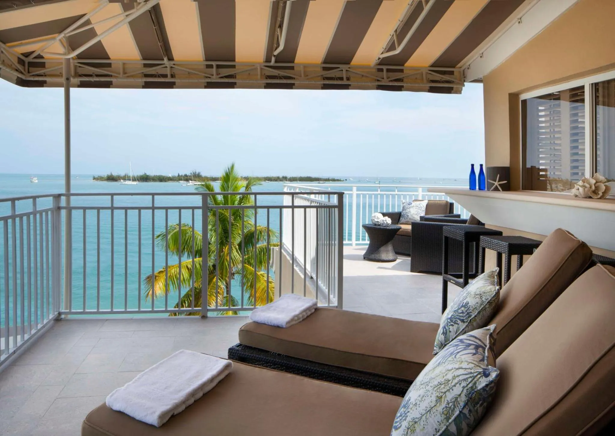 Terrasse avec transats et vue sur la mer.