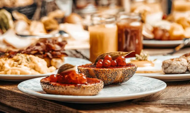 Une table est garnie de divers plats pour le petit-déjeuner.