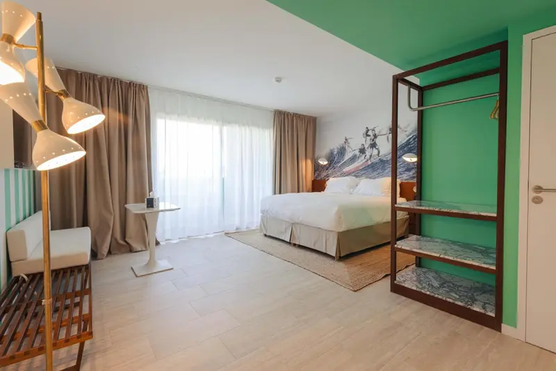 Une chambre lumineuse avec un grand lit et un espace détente.