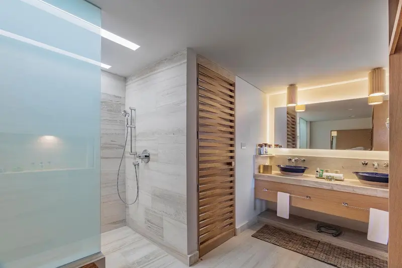 Une salle de bain moderne avec douche à l'italienne et double vasque.