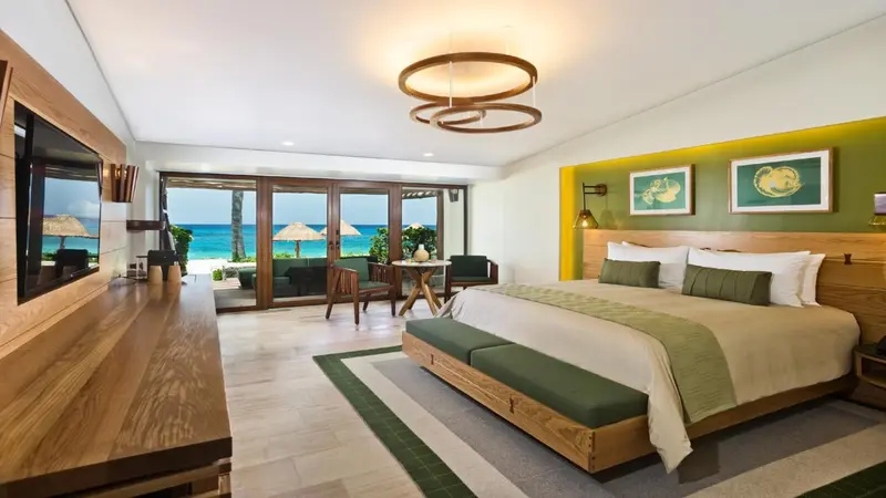 Une chambre lumineuse avec un grand lit et une vue sur la mer.