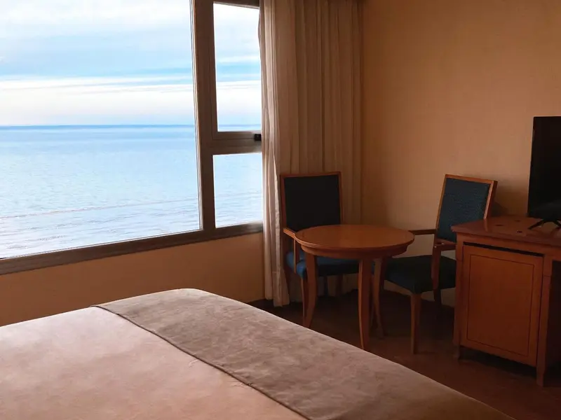 Une chambre avec vue sur la mer et un coin salon.