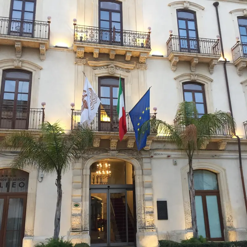 Facade d'un bâtiment à balcons et drapeaux.