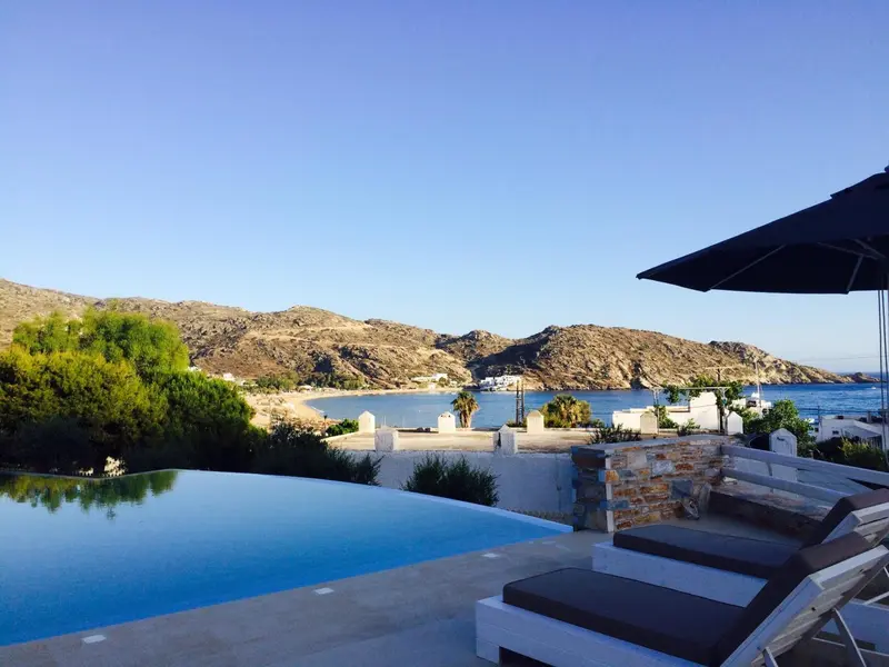 Vue sur une piscine à débordement et un paysage montagneux en bord de mer.