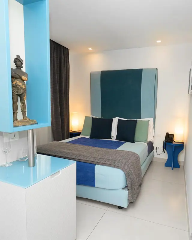 Une chambre lumineuse avec un grand lit et une décoration moderne.