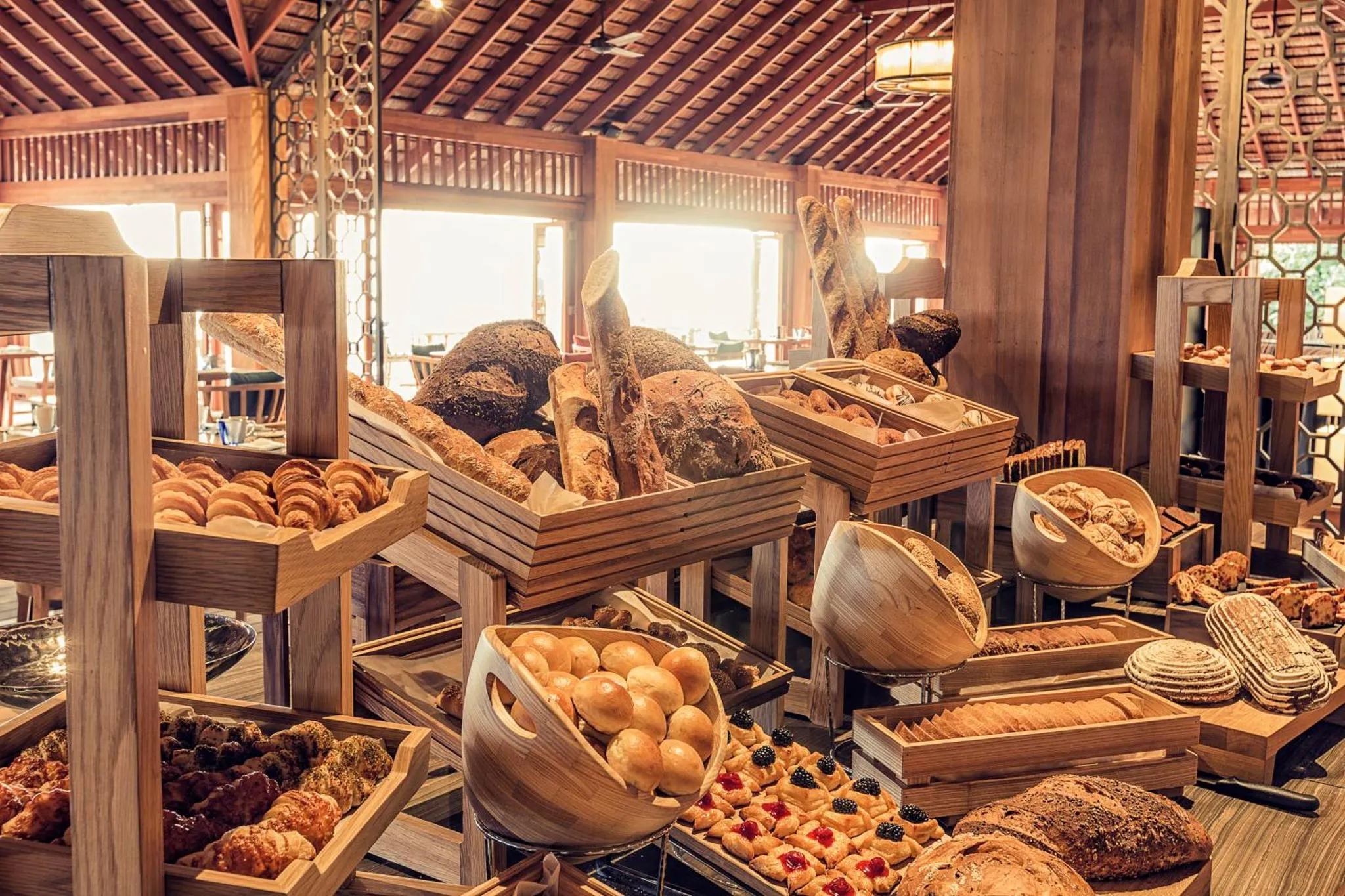Un buffet propose une grande variété de pains et de viennoiseries.