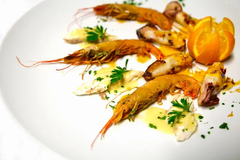 Assiette de fruits de mer et d'agrumes décorée de persil.