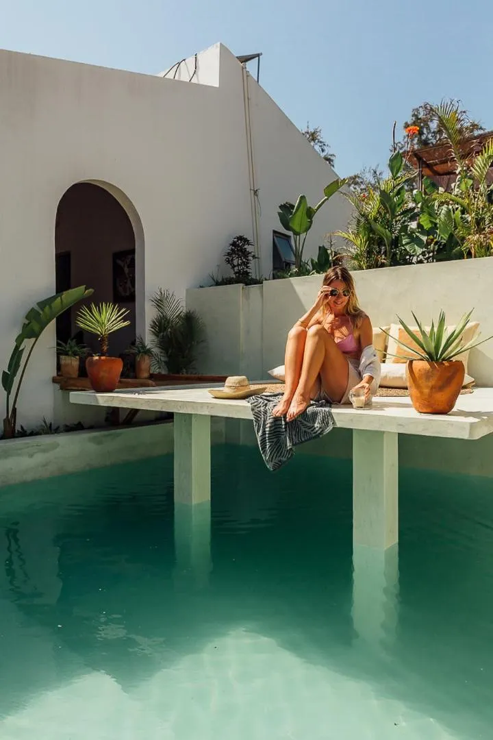 Une femme se détend au bord d'une piscine ensoleillée.