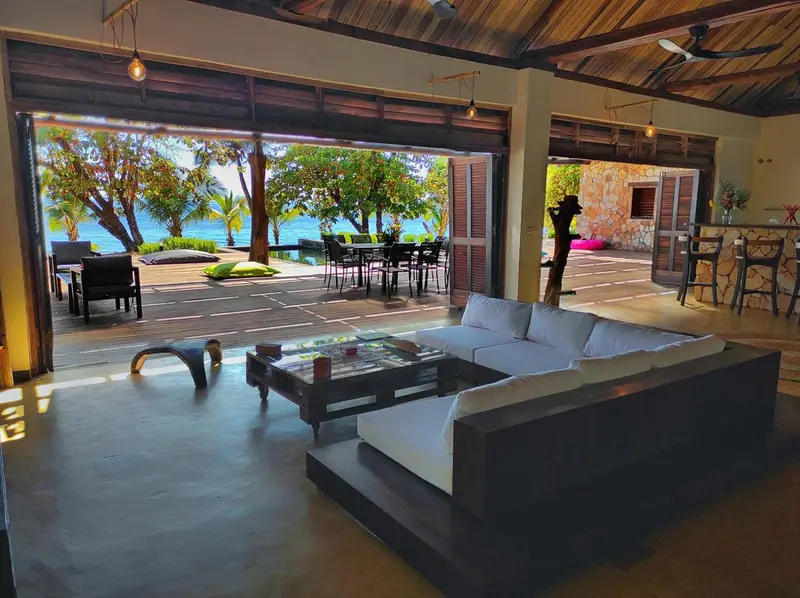 Espace de détente intérieur avec canapés et vue sur la mer.