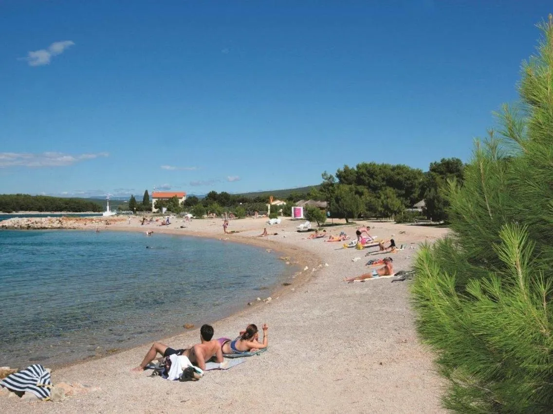 Une plage de sable avec des personnes se relaxant au soleil.