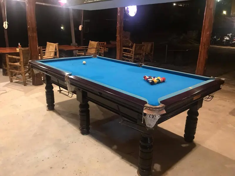 Table de billard dans un espace extérieur éclairé.