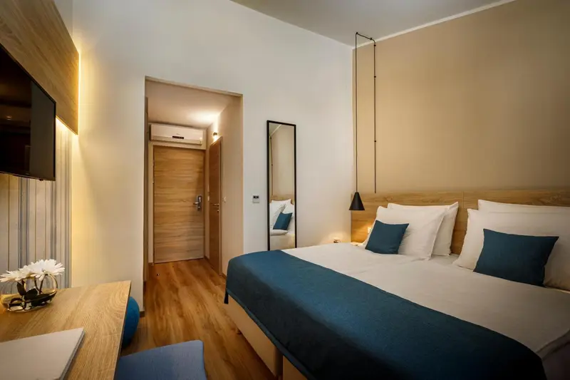 Une chambre lumineuse avec un grand lit et un bureau.