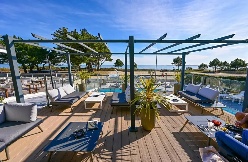 Terrasse aménagée avec salon et vue sur la mer.