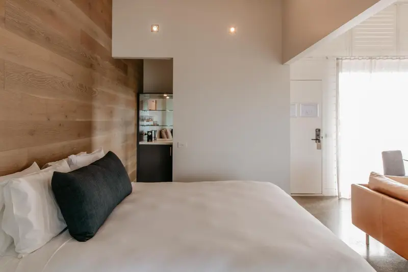 Une chambre lumineuse avec un grand lit et un accès à une terrasse.