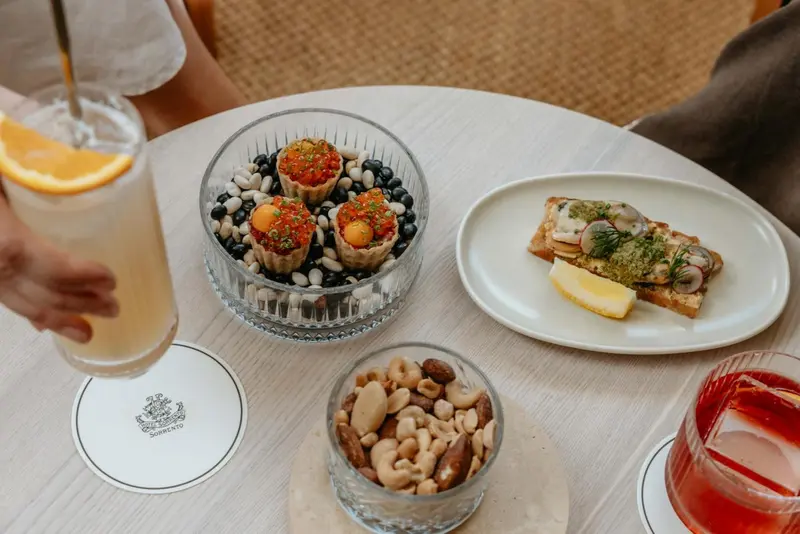 Une table est dressée avec des boissons et des amuse-gueules.