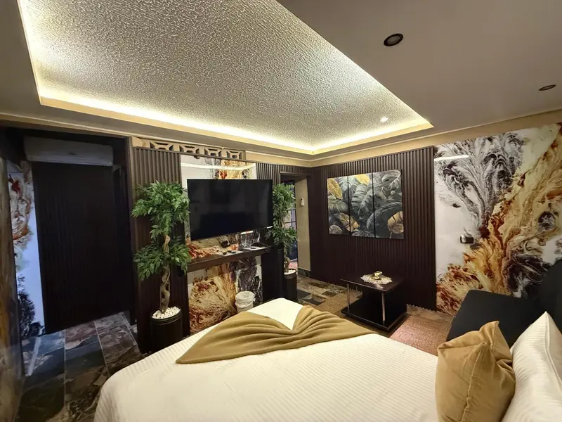 Une chambre d'hôtel moderne avec un grand lit et une décoration murale abstraite.