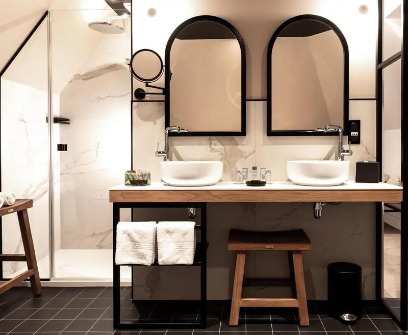Une salle de bain moderne avec deux vasques et un grand miroir.