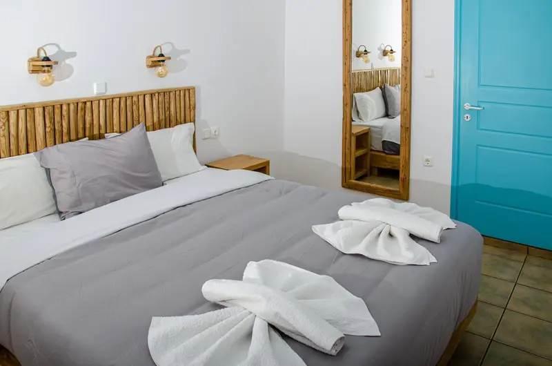 Une chambre lumineuse avec un grand lit et une décoration en bois.